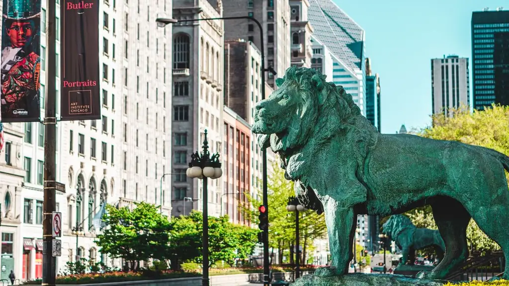 Iconic lion statues outside Art Institute of Chicago amidst urban buildings and streets