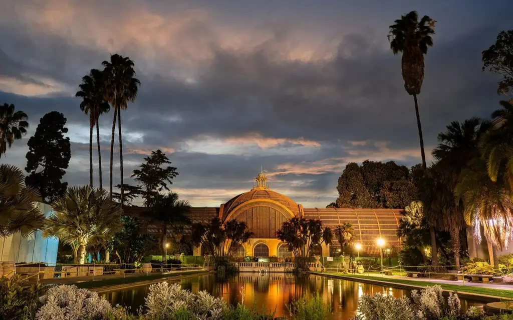Dramatic sunset over the historic Botanical Building and reflecting pond in Balboa Park, San Diego