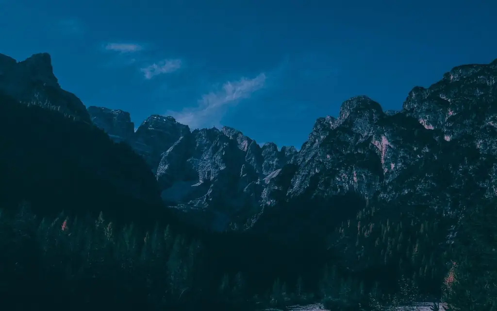Stunning view of rugged mountains under a vibrant blue sky, perfect for nature exploration enthusiasts
