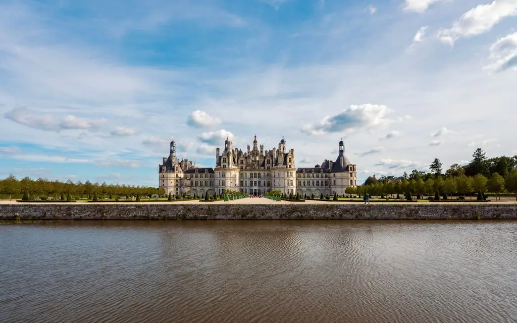 Majestic Château de Chambord with a picturesque reflection on a sunny day in France