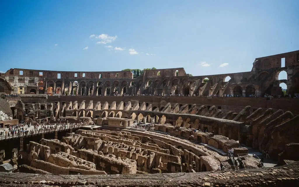 Explore the iconic Colosseum in Rome under a clear blue sky. Perfect for travel inspiration