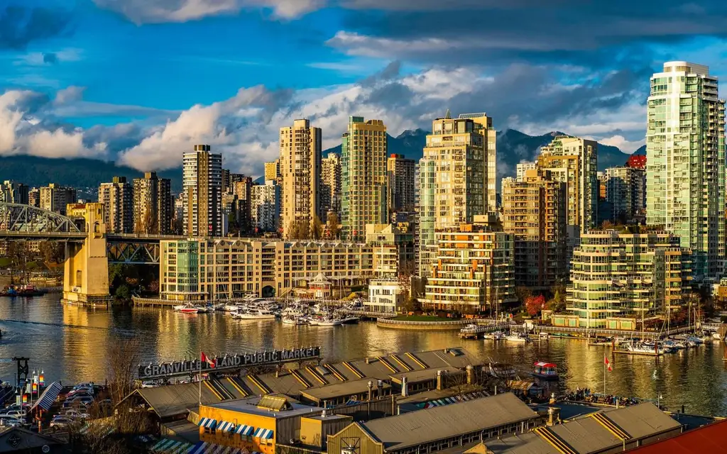 Beautiful view of Vancouver's modern skyline and Granville Island public market at sunset