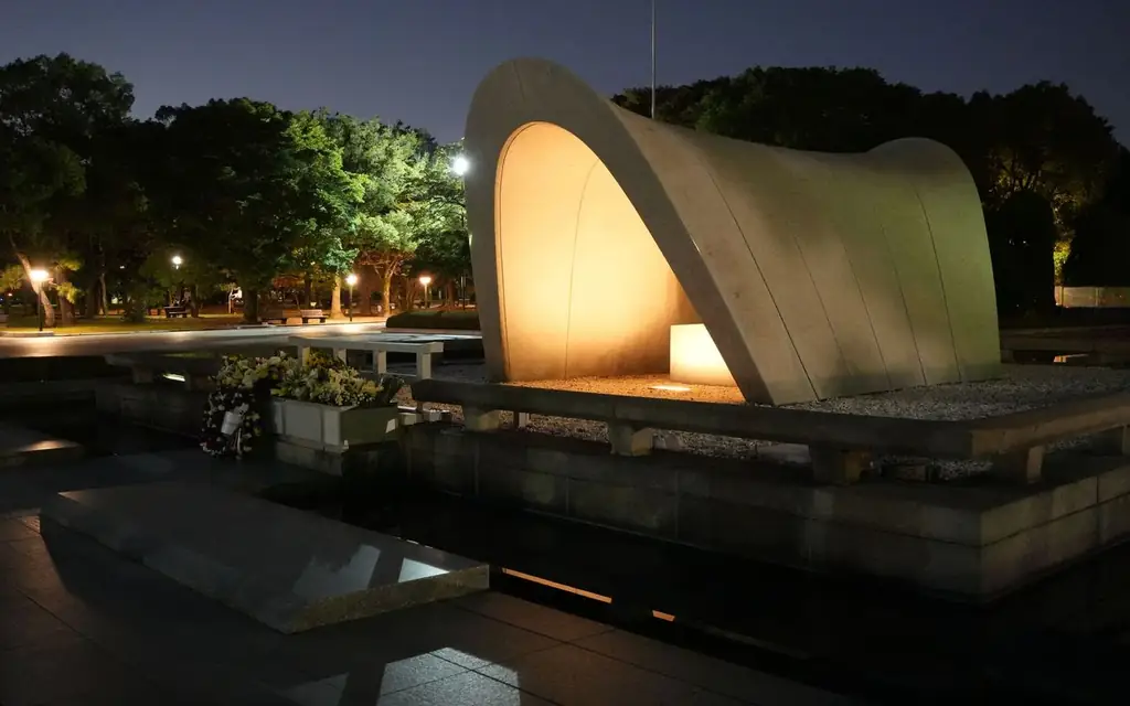 Illuminated Hiroshima Peace Memorial Park captured at night, serene and hauntingly beautiful