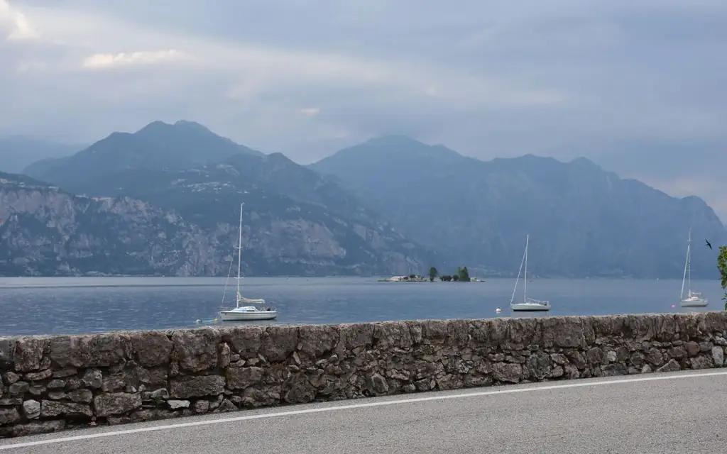 Scenic view of Lake Garda with sailing boats and mountains in the background