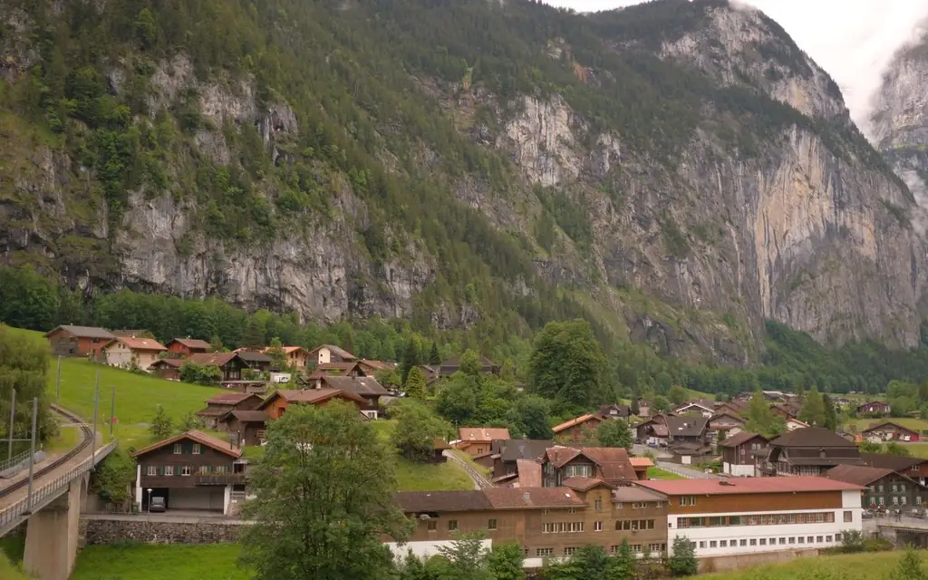Lauterbrunnen village nestled amidst the Swiss Alps, showcasing charming chalets and stunning mountain views