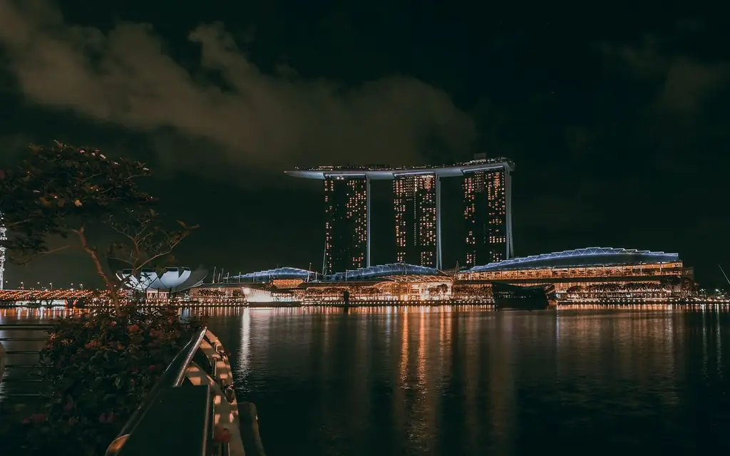 Nighttime cityscape of Marina Bay Sands, Singapore, with reflections on water