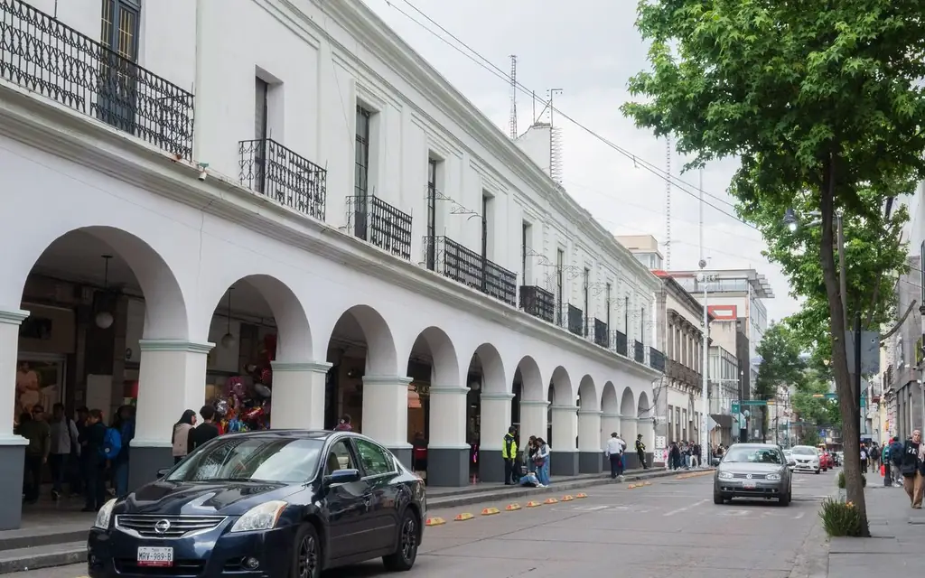 A bustling street scene in the historic center of Toluca de Lerdo, Mexico, showcasing colonial architecture
