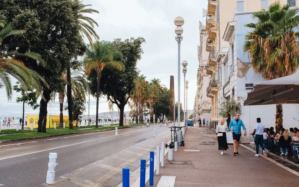 A sunny day at Promenade des Anglais in Nice, with people enjoying the vibrant city street