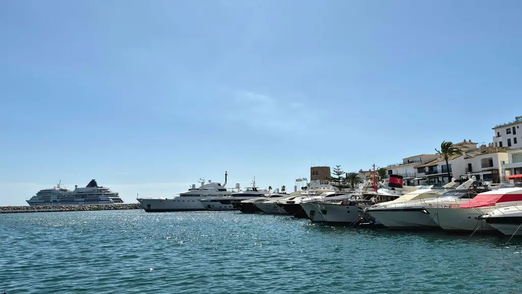 Elegant yachts docked at the stunning Puerto Banús Marina in Marbella, Spain, under clear blue skies