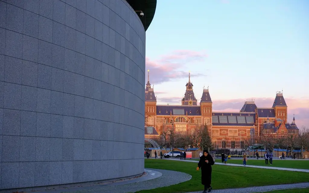 Captivating view of the Rijksmuseum and park at sunset in Amsterdam, capturing urban charm