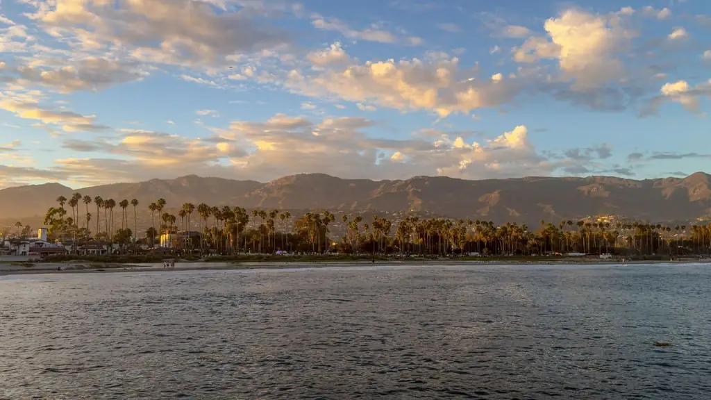 Beautiful coastal view of Santa Barbara with palm trees and mountains during sunset, capturing serene beauty