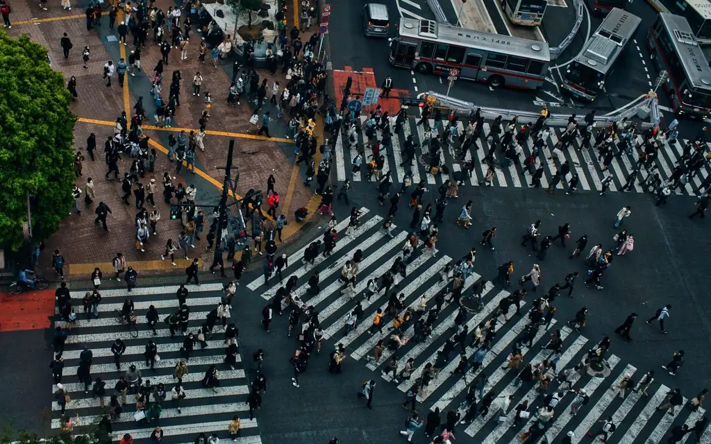 Crowded Shibuya Crossing in Tokyo from above, showcasing urban life and movement