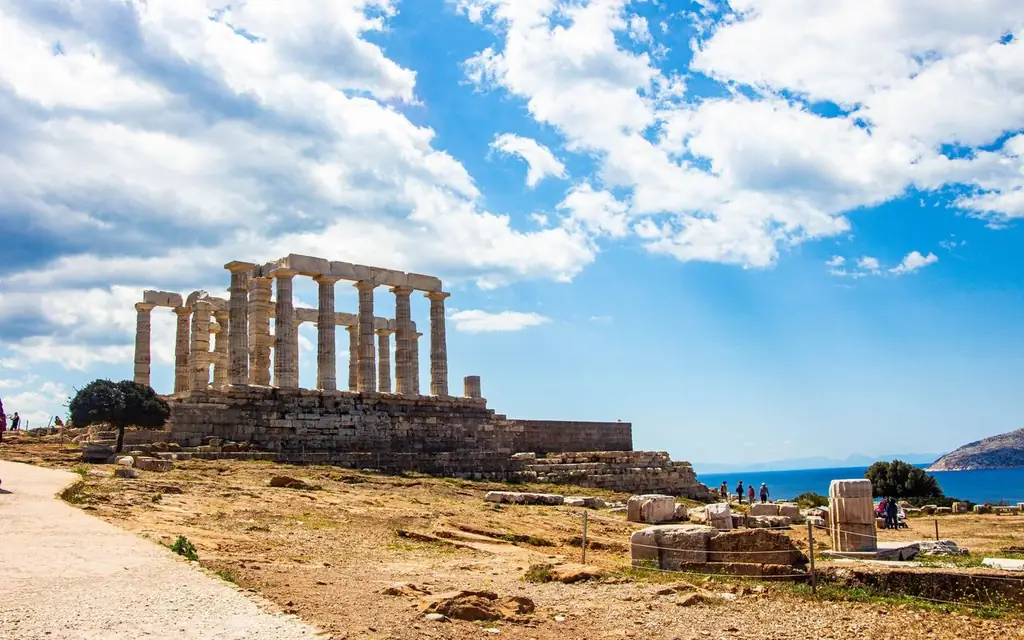 Explore the iconic Temple of Poseidon at Cape Sounion, Greece, under a vibrant blue sky