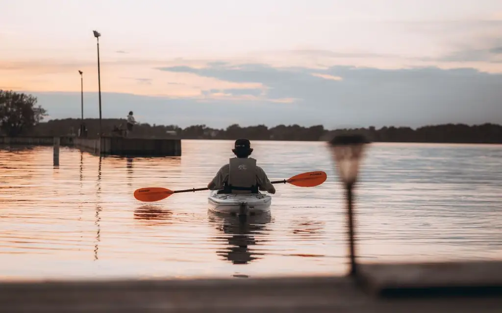 Man enjoying a peaceful canoe ride at sunset in Thousand Island Park, NY