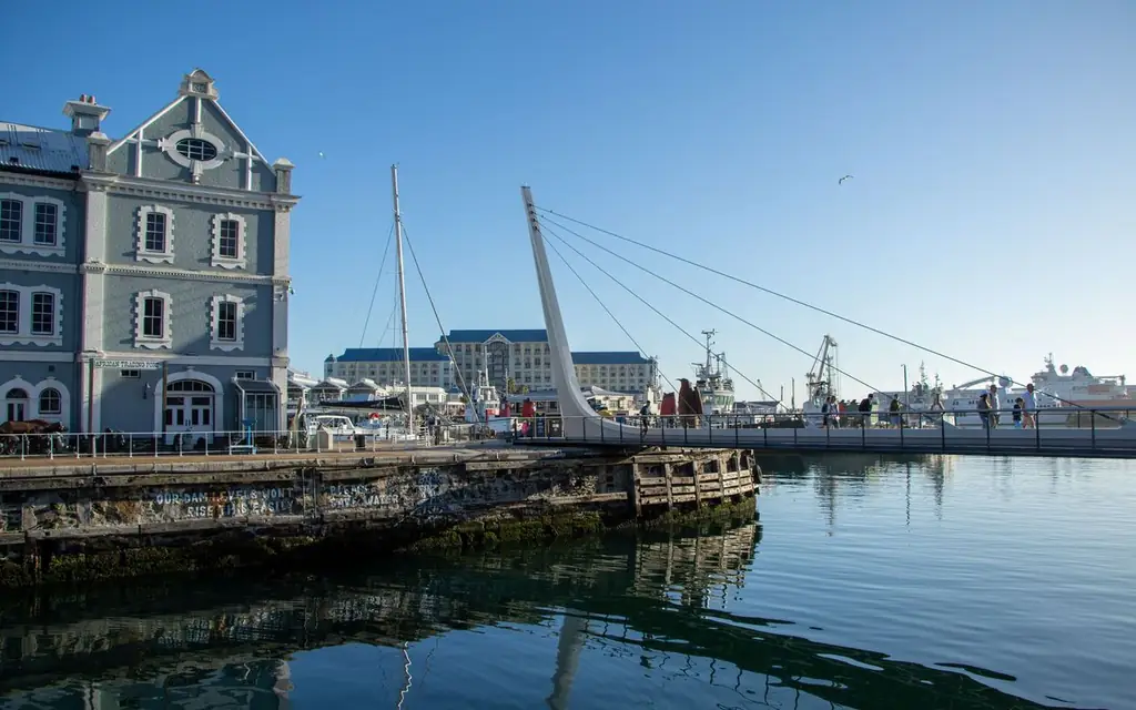 Explore Cape Town's vibrant waterfront with iconic architecture and bustling harbor activity