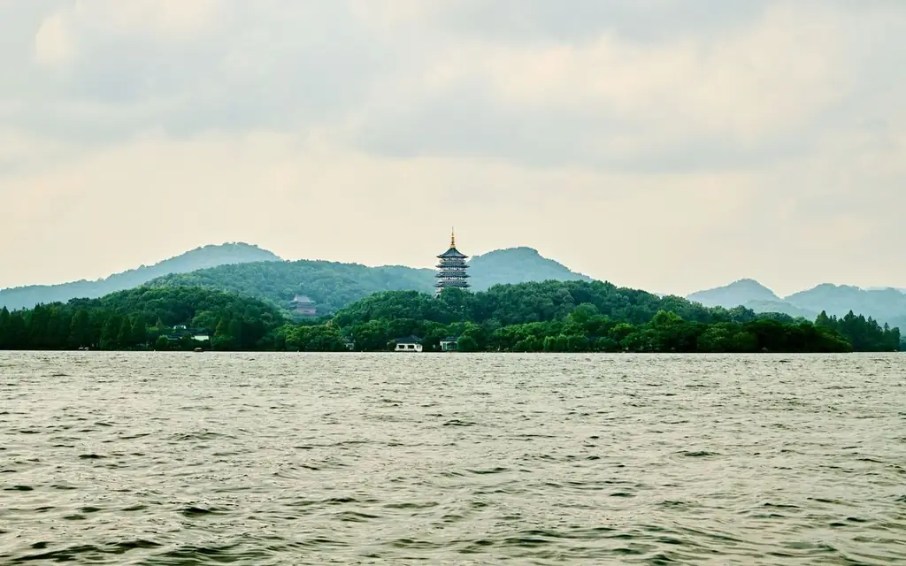 Scenic view of West Lake with trees and iconic pagoda in the distance