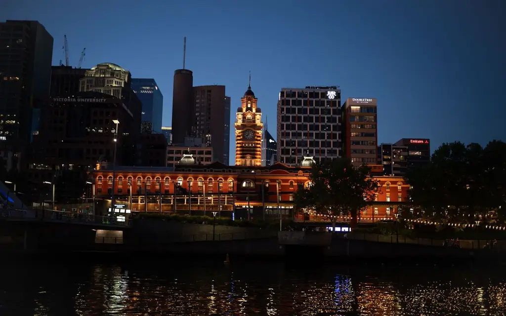 Beautiful night view of Flinders Street Station and Melbourne skyline reflecting over Yarra River