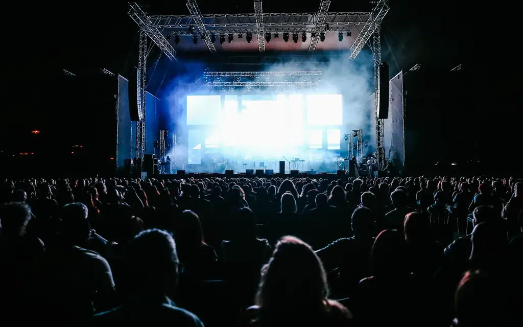 A concert crowd under stage lights