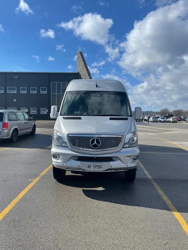 Silver Mercedes-Benz Sprinter executive van parked, seen from the front