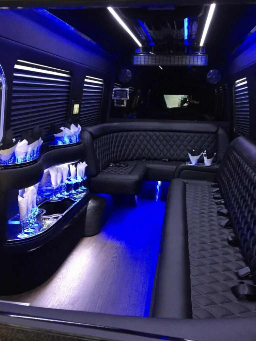Jet Sprinter rear lounge seen from the door, with side seating and privacy blinds