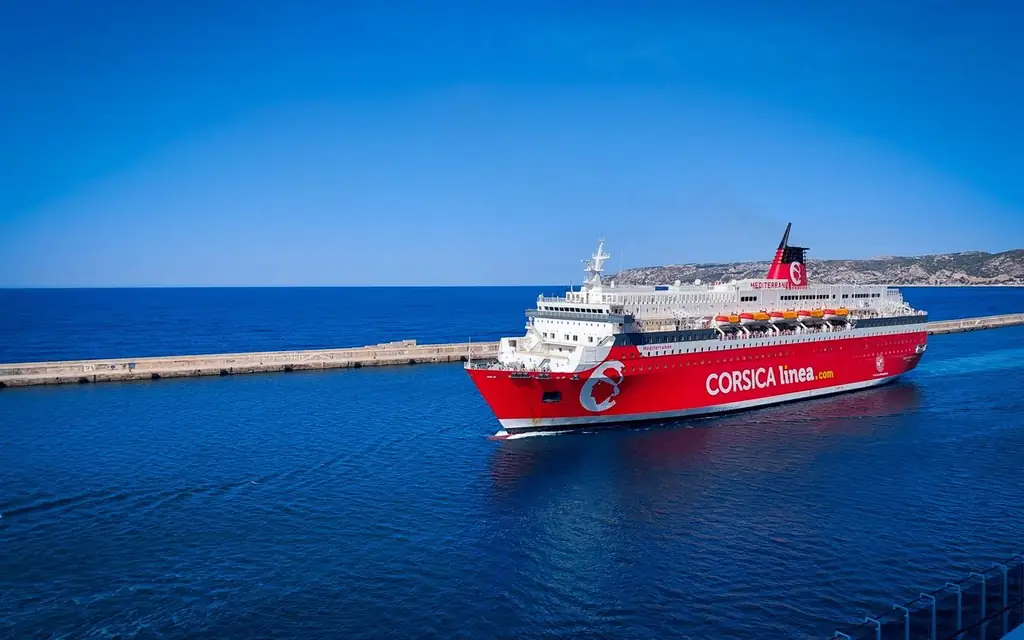 Red cruise ship by Civitavecchia port under clear blue sky, Lazio, Italy