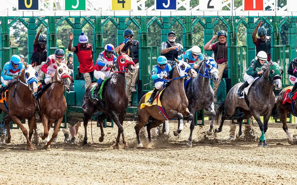 Dynamic scene of jockeys and horses launching from starting gate in a competitive race