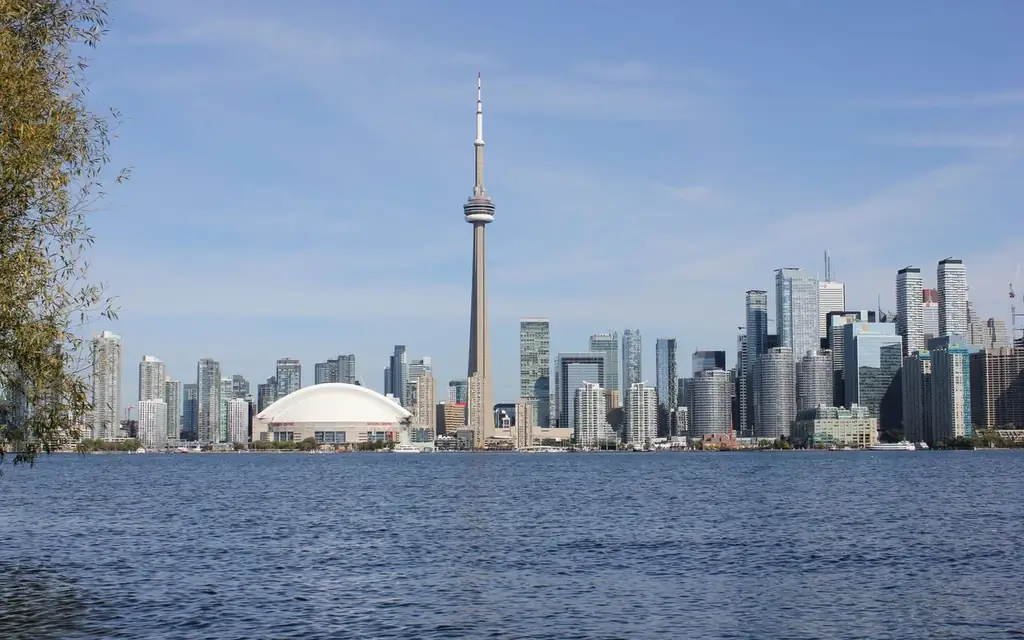 Captivating view of Toronto skyline featuring the iconic CN Tower and Lake Ontario on a bright day