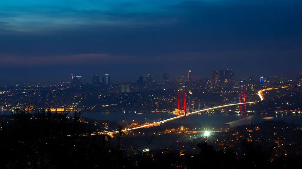 Illuminated Bosphorus Bridge and Istanbul cityscape captured at night creating a breathtaking urban scene