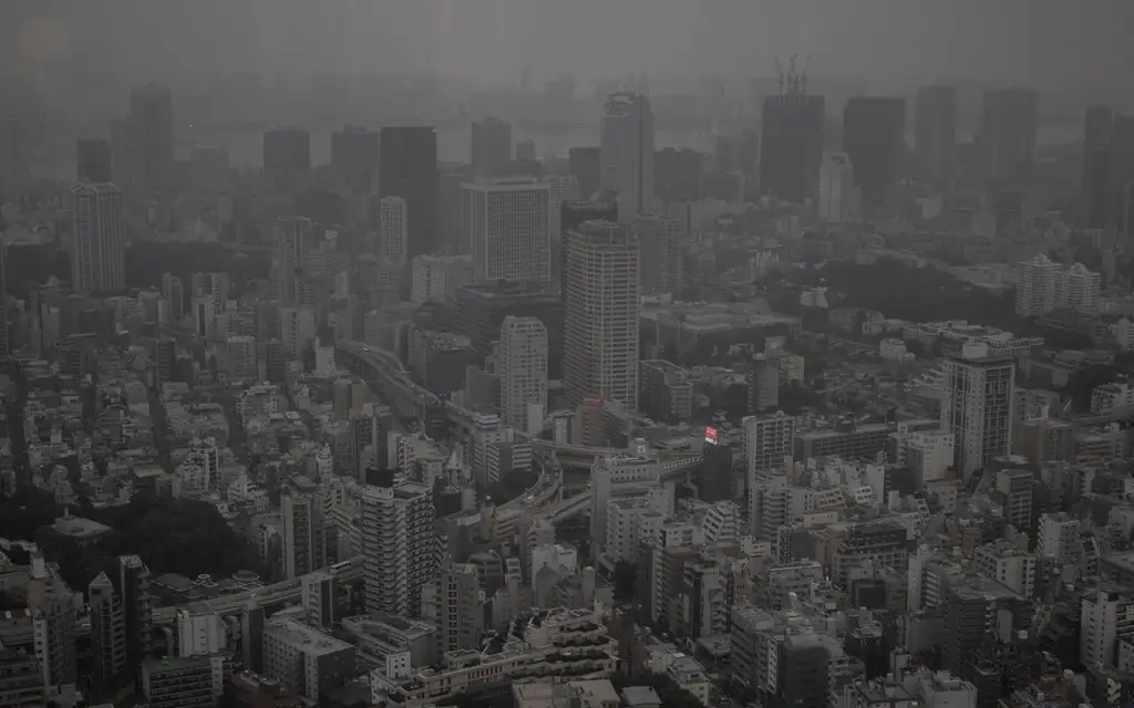 Aerial view of a foggy Tokyo cityscape showcasing skyscrapers and urban density
